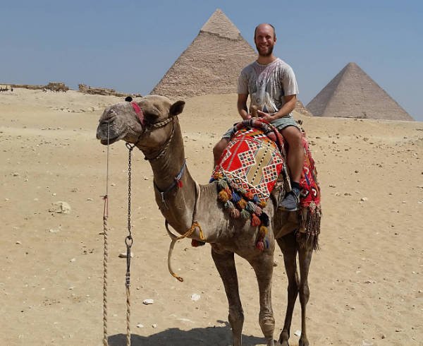 Kenny Palurintano on a camel in the desert